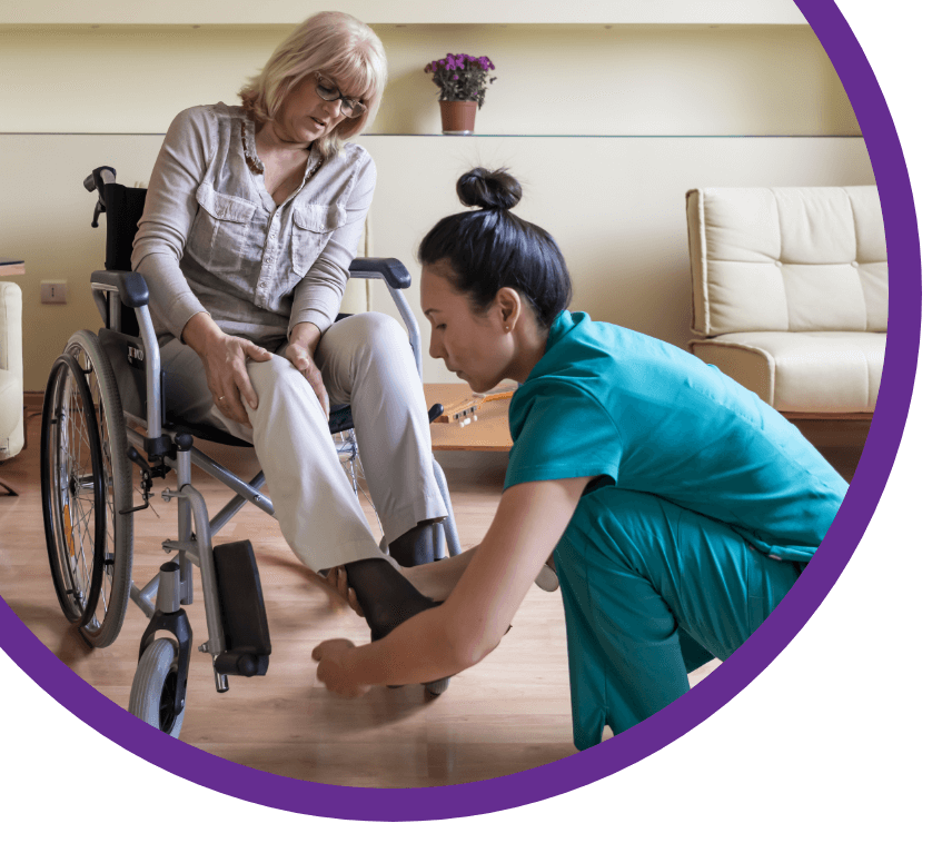 Nurse Assisting Wheel Bound Woman Image Left